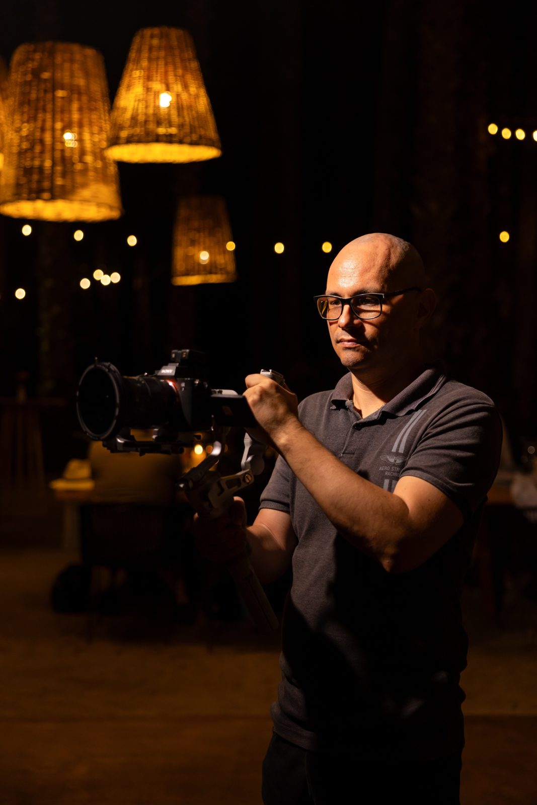 Etzael Salazar filming with a camera on a gimbal at night